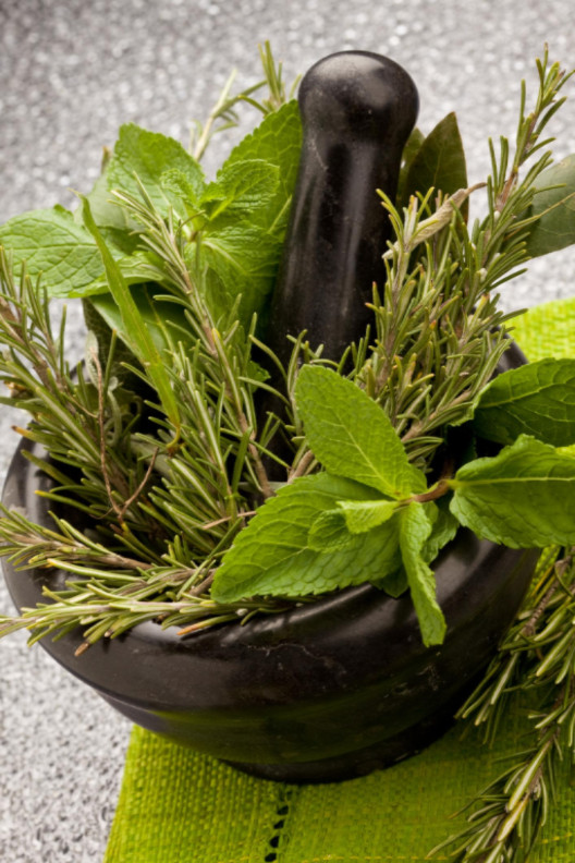fresh aromatic herbs in a mortar