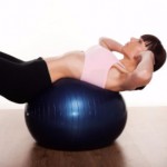 woman exercising with blue ball